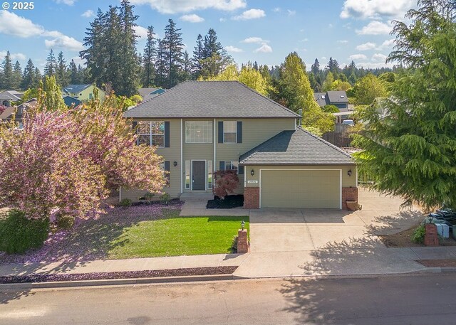 traditional home featuring concrete driveway, a garage, a front lawn, and brick siding
