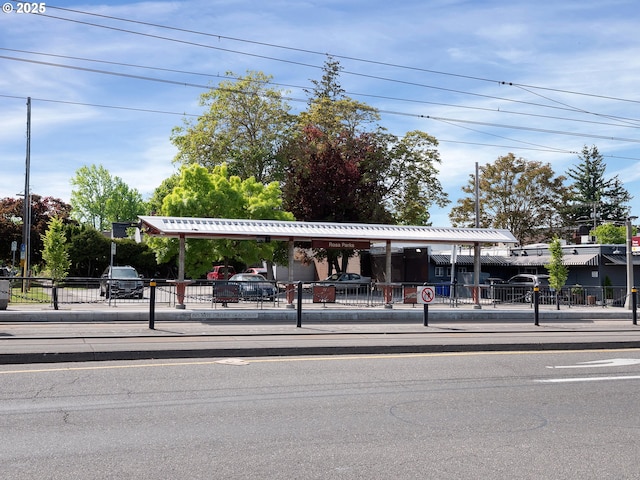 view of asphalt street featuring curbs