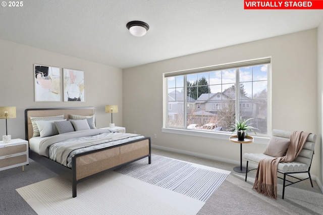 bedroom with carpet flooring and baseboards