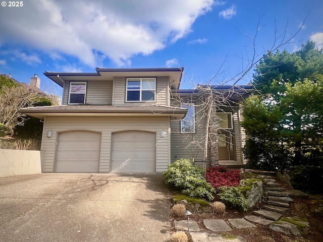 view of front of home with concrete driveway and a garage