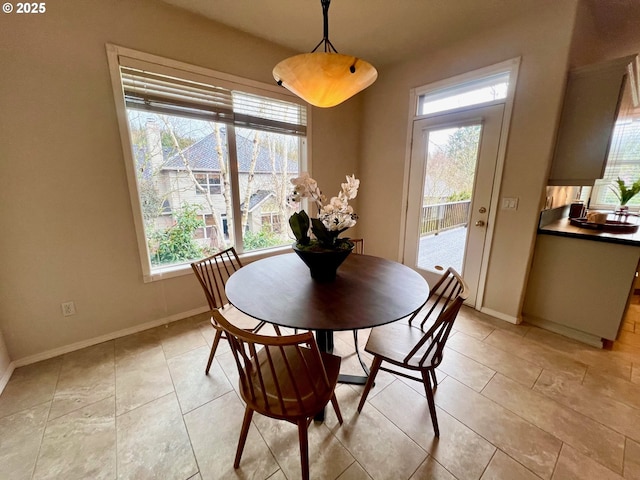 dining area with light tile patterned flooring and baseboards