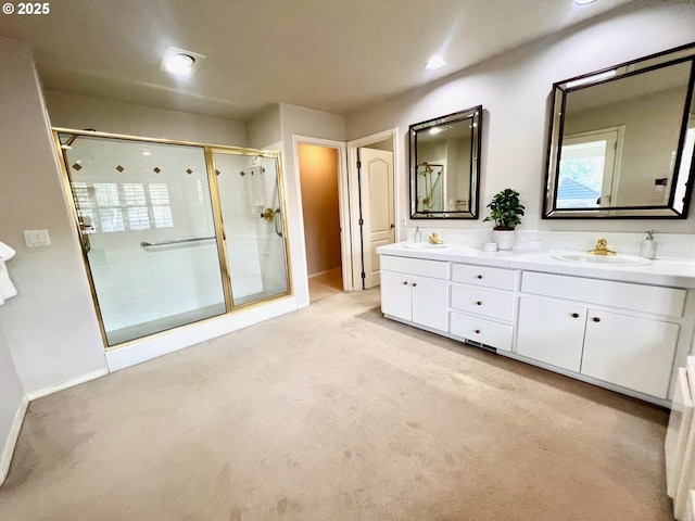 full bathroom with a sink, baseboards, double vanity, and a shower stall