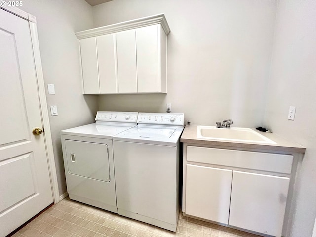 washroom featuring washer and clothes dryer, cabinet space, and a sink