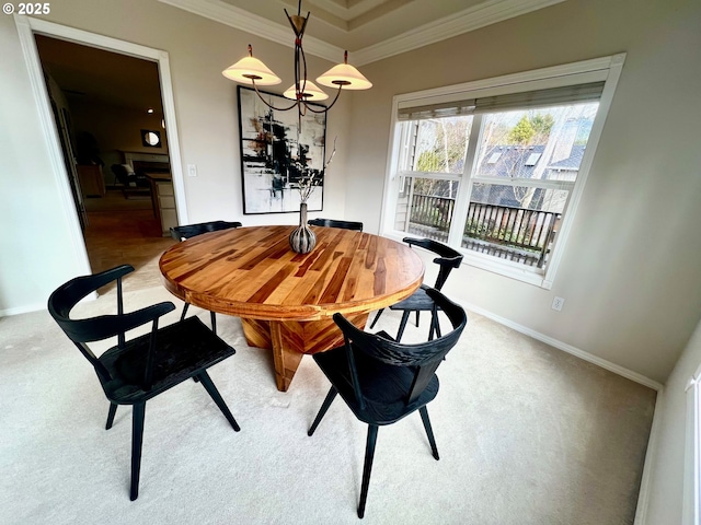 dining room featuring crown molding and baseboards