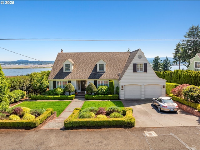 6413 Buena Vista Dr, Vancouver, WA 98661 - cape cod-style house featuring concrete driveway, an attached garage, a water view, and a front yard