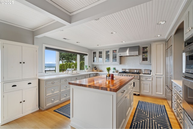 6413 Buena Vista Dr, Vancouver, WA 98661 - kitchen featuring wood counters, wall chimney range hood, high quality appliances, light wood-style floors, and a kitchen island