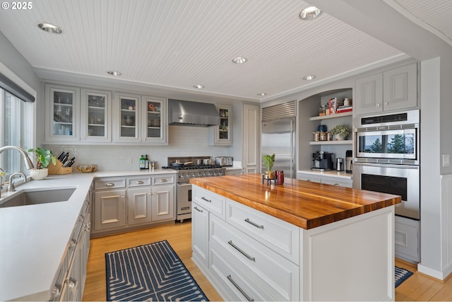 6413 Buena Vista Dr, Vancouver, WA 98661 - kitchen featuring high quality appliances, wall chimney range hood, wooden counters, light wood-style flooring, and backsplash