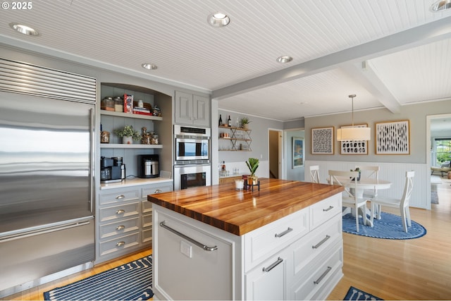 6413 Buena Vista Dr, Vancouver, WA 98661 - kitchen with appliances with stainless steel finishes, wooden counters, light wood finished floors, open shelves, and pendant lighting