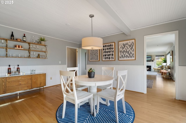 6413 Buena Vista Dr, Vancouver, WA 98661 - dining area featuring wainscoting, light wood-type flooring, a bar, beam ceiling, and crown molding