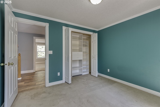 9373 SW Fast Pl, Portland, OR 97223 - unfurnished bedroom with crown molding, carpet flooring, a closet, and a textured ceiling