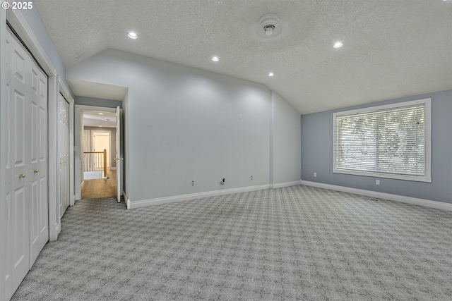 9373 SW Fast Pl, Portland, OR 97223 - unfurnished room with lofted ceiling, carpet, a textured ceiling, and recessed lighting