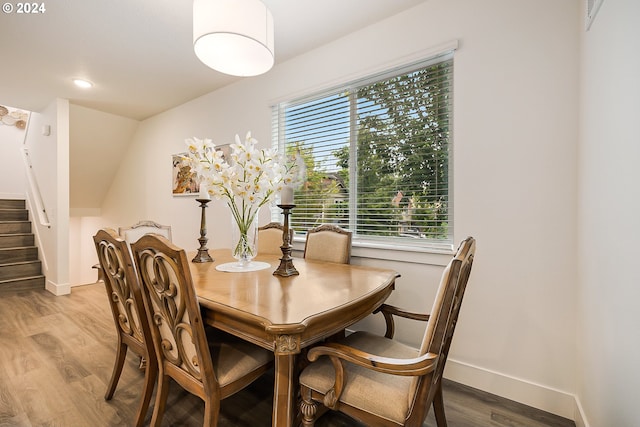 dining area with stairway, light wood-type flooring, and baseboards