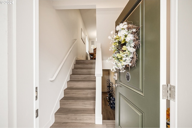 stairs featuring wood finished floors