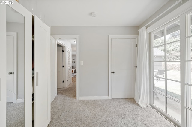 2822 NE Fremont Dr, Portland, OR 97220 - unfurnished bedroom featuring light colored carpet and access to exterior