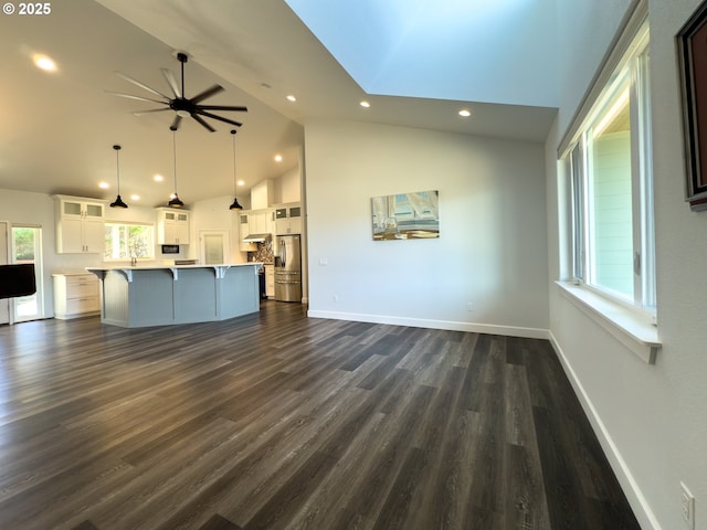 unfurnished living room with recessed lighting, dark wood finished floors, baseboards, and ceiling fan
