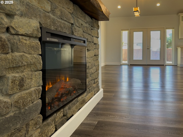 living area with baseboards, dark wood-style floors, french doors, a fireplace, and recessed lighting