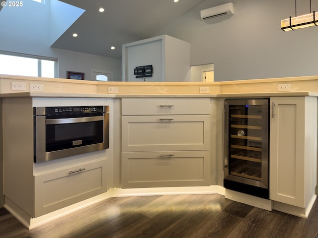 kitchen with oven, beverage cooler, white cabinets, light countertops, and dark wood finished floors