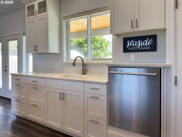 kitchen featuring a sink, white cabinetry, light countertops, and dishwasher