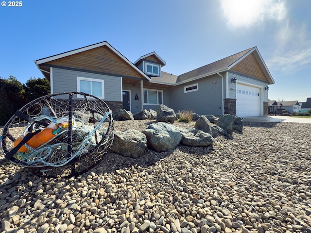 view of front of home featuring an attached garage and stone siding