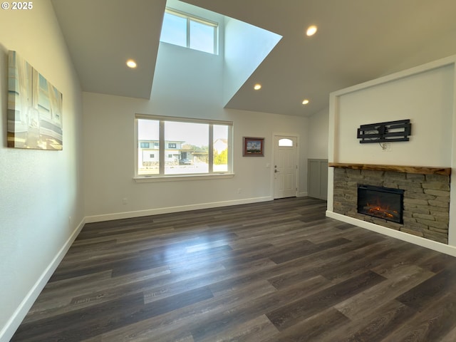 unfurnished living room featuring dark wood-type flooring, a fireplace, recessed lighting, and baseboards