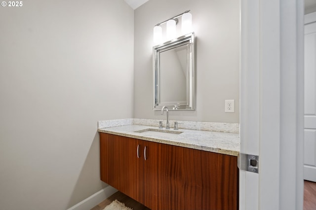 bathroom with vanity and baseboards