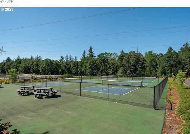 view of tennis court featuring fence