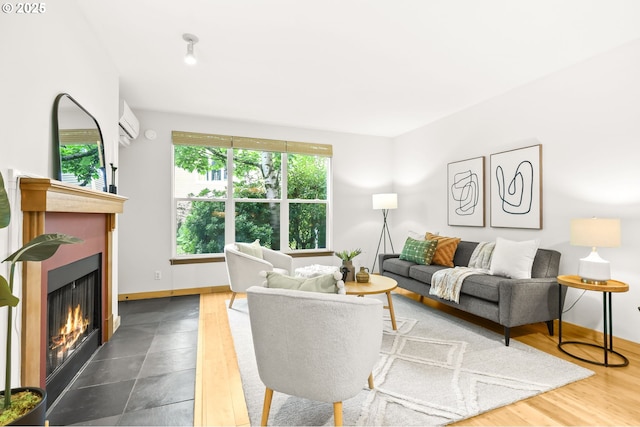 1710 S Harbor Way Unit 201, Portland, OR 97201 - living area featuring a warm lit fireplace, a wall mounted AC, and baseboards