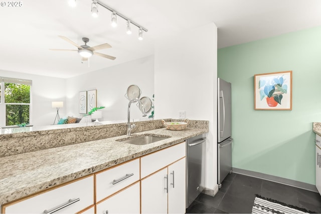 1710 S Harbor Way Unit 201, Portland, OR 97201 - kitchen featuring a sink, stainless steel appliances, dark tile patterned flooring, a ceiling fan, and light stone counters