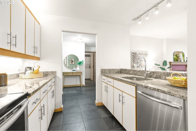1710 S Harbor Way Unit 201, Portland, OR 97201 - kitchen with appliances with stainless steel finishes, a sink, and white cabinetry