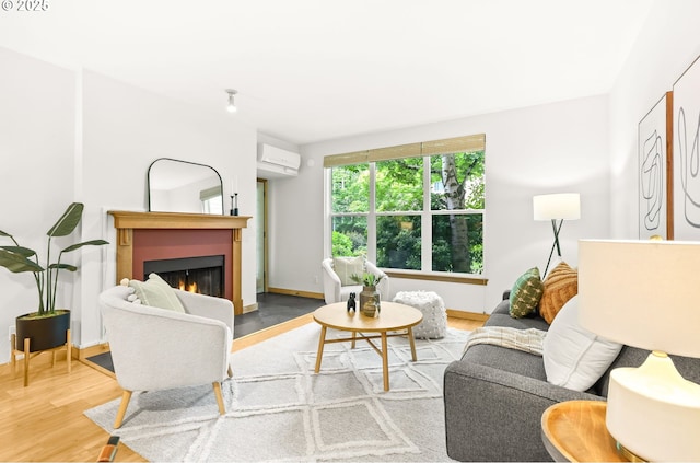 1710 S Harbor Way Unit 201, Portland, OR 97201 - living room with wood finished floors, an AC wall unit, a warm lit fireplace, and baseboards