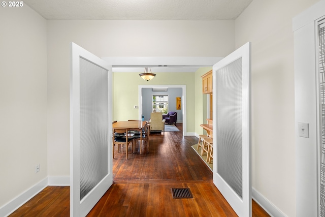 4536 N Haight Ave, Portland, OR 97217 - hallway with wood-type flooring, a heating unit, visible vents, and baseboards