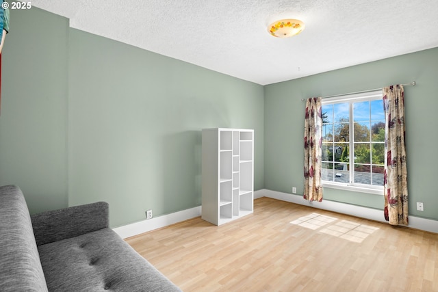 4536 N Haight Ave, Portland, OR 97217 - sitting room featuring a textured ceiling, baseboards, and wood finished floors