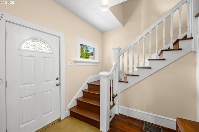 4536 N Haight Ave, Portland, OR 97217 - entrance foyer with baseboards, visible vents, and stairway