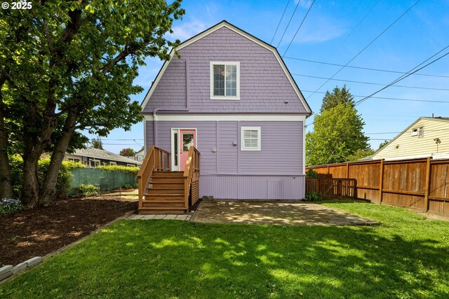 4536 N Haight Ave, Portland, OR 97217 - back of property with a lawn, a patio, a fenced backyard, and a gambrel roof