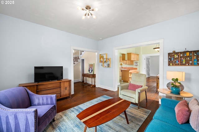 4536 N Haight Ave, Portland, OR 97217 - living area with baseboards, stairs, wood finished floors, and a chandelier