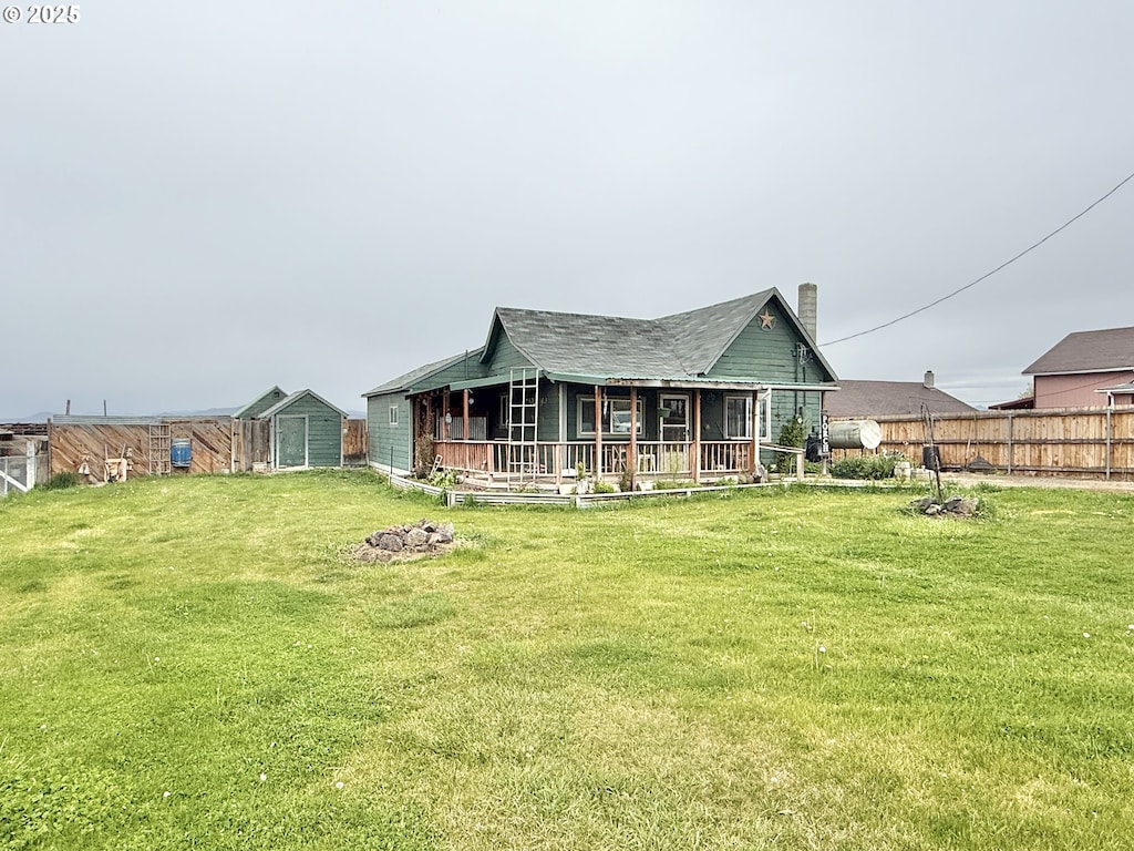 217 Main St, Unity, OR 97884 - rear view of house with a chimney and covered porch