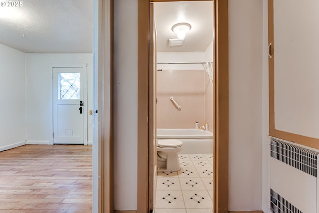 1327 Grant St, Eugene, OR 97402 - hallway featuring light wood-type flooring and radiator heating unit