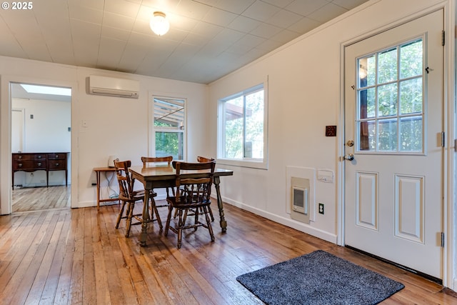 1327 Grant St, Eugene, OR 97402 - dining area with a wall mounted AC, light wood-style flooring, heating unit, baseboards, and ornamental molding