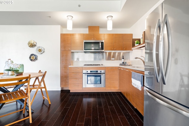 3601 S River Pkwy Unit 800, Portland, OR 97239 - kitchen featuring appliances with stainless steel finishes, light countertops, and dark wood finished floors