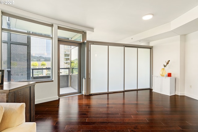 3601 S River Pkwy Unit 800, Portland, OR 97239 - unfurnished living room featuring hardwood / wood-style flooring and baseboards
