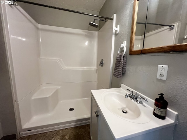 312 NW 7th St, Pendleton, OR 97801 - bathroom featuring a textured wall, a shower, and vanity