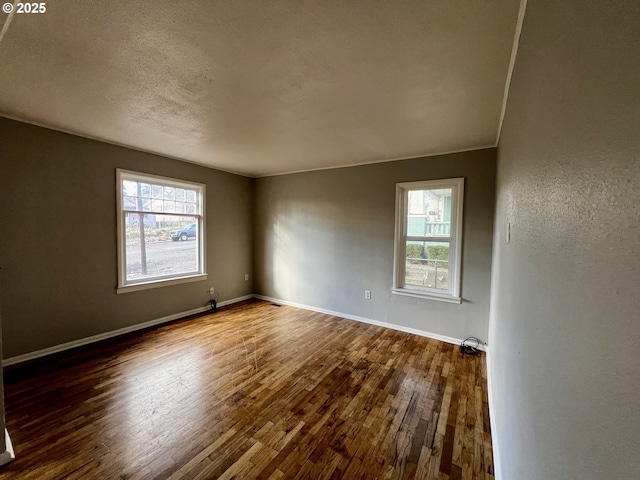 312 NW 7th St, Pendleton, OR 97801 - empty room featuring healthy amount of natural light, dark wood finished floors, and a textured ceiling