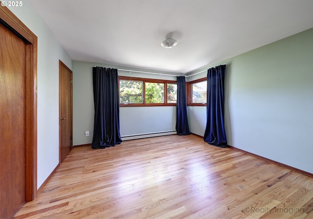 5730 N Harvard St, Portland, OR 97203 - spare room featuring a baseboard radiator, light wood-style floors, and baseboards