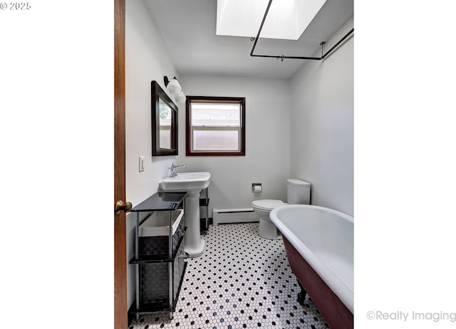 5730 N Harvard St, Portland, OR 97203 - bathroom featuring a baseboard heating unit and a freestanding tub