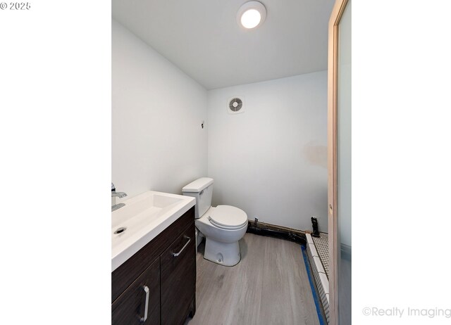 5730 N Harvard St, Portland, OR 97203 - bathroom with wood finished floors, vanity, and toilet