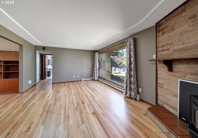 5730 N Harvard St, Portland, OR 97203 - unfurnished living room with light wood-style flooring, a baseboard radiator, a fireplace, and baseboards