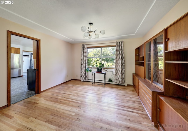 5730 N Harvard St, Portland, OR 97203 - unfurnished dining area with a chandelier, light wood-style floors, and baseboards