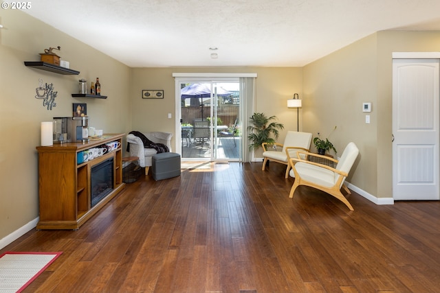 sitting room with baseboards and hardwood / wood-style floors