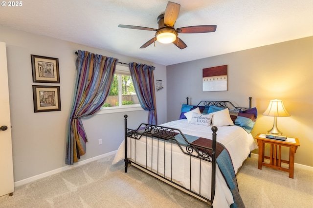 bedroom featuring carpet floors, a ceiling fan, and baseboards