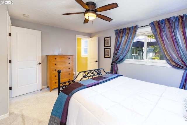 bedroom with baseboards, carpet flooring, and a ceiling fan